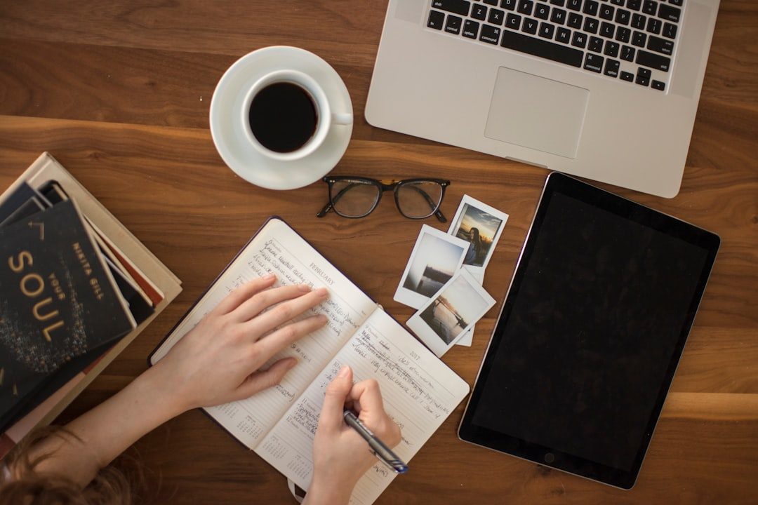 person holding ballpoint pen writing on notebook — creative Writing and Content Generation